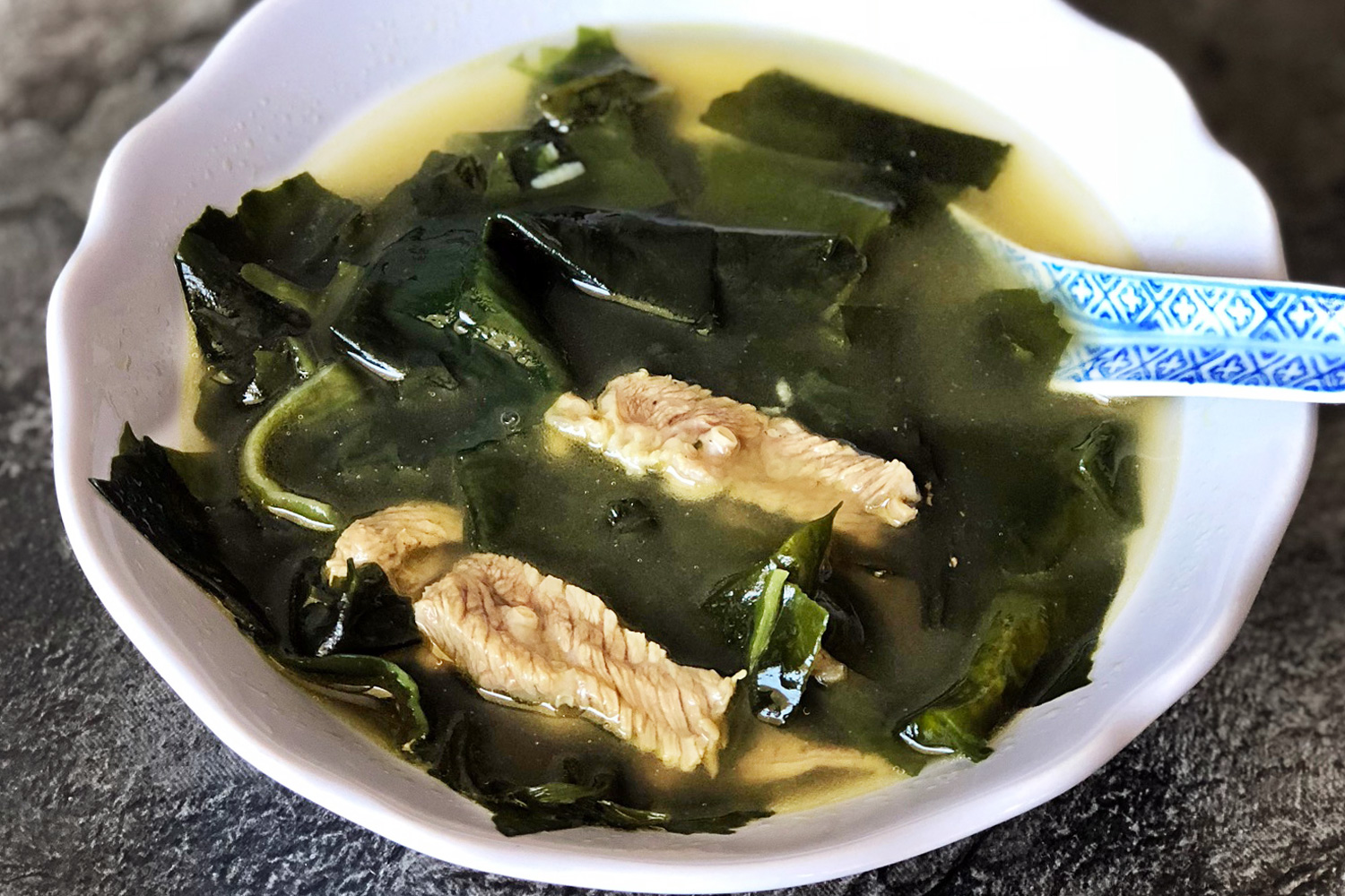 Miyeok Guk is Korean Seaweed Soup cooked in a soy-based broth with beef tra...