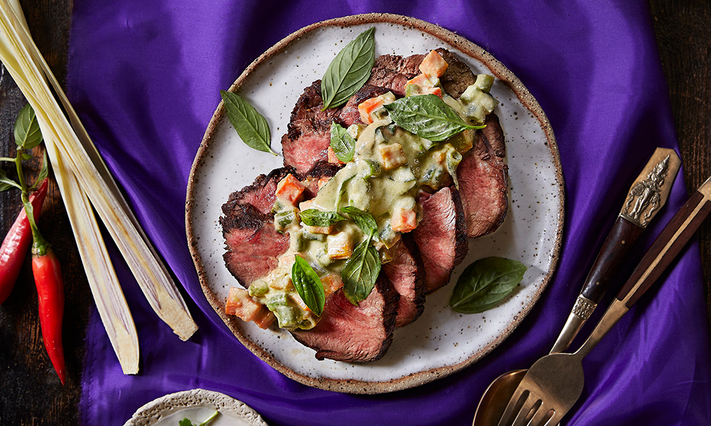Thai Green Curry sauce drizzled over grilled beef steak