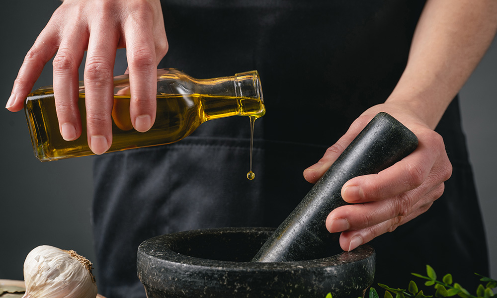 Pouring Extra Virgin Olive Oil in Mortar and Pestle