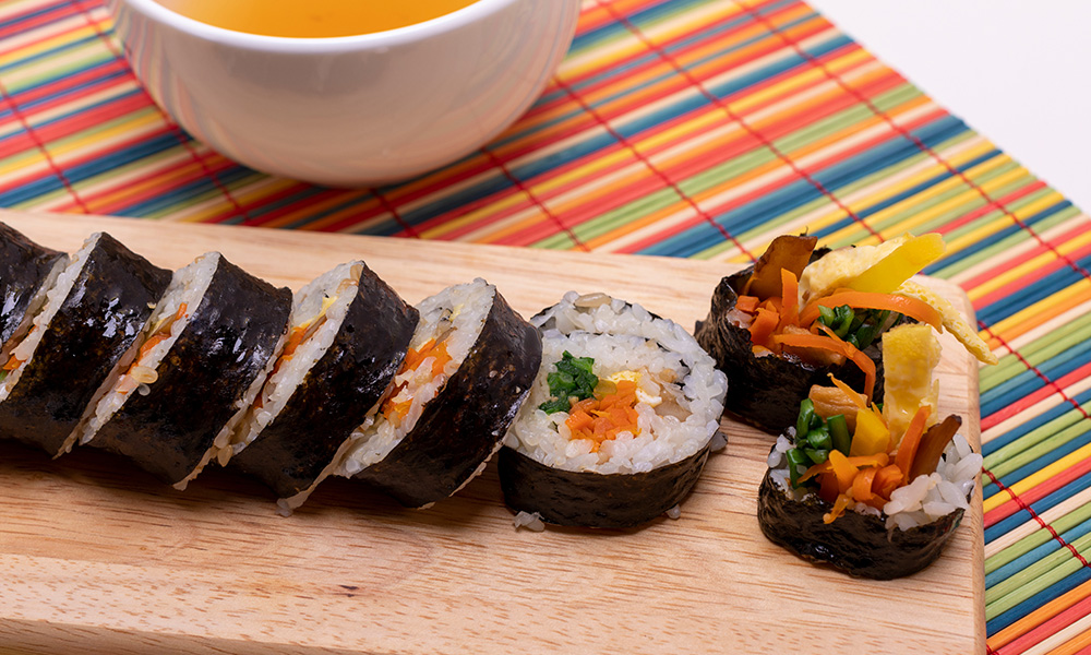 Sliced gimbap on a wooden board