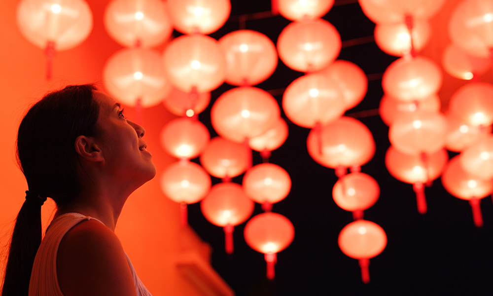 Woman looking at red lanterns