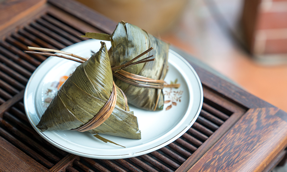 two zongzi on a plate