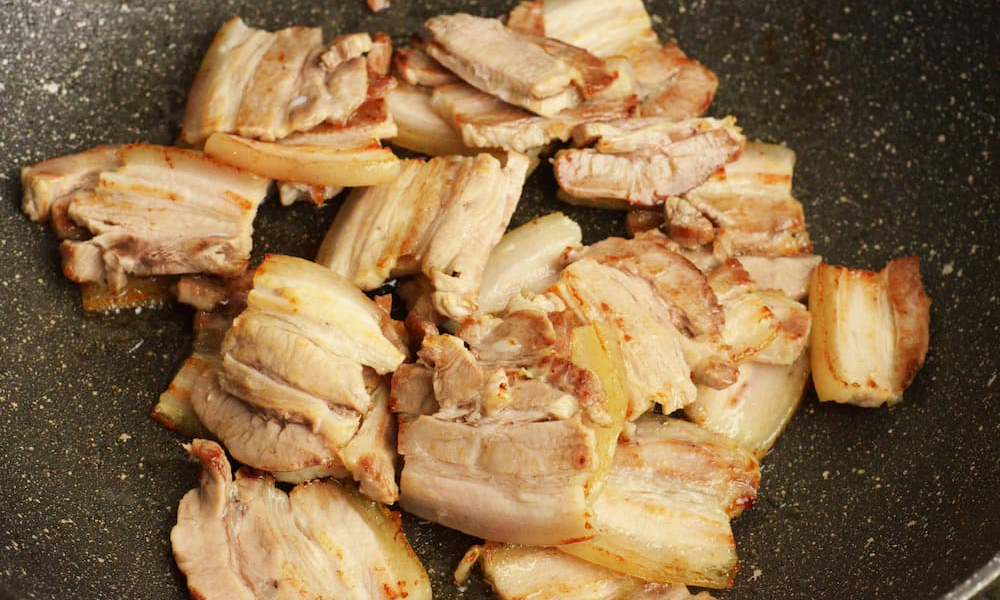 Searing pork belly in wok